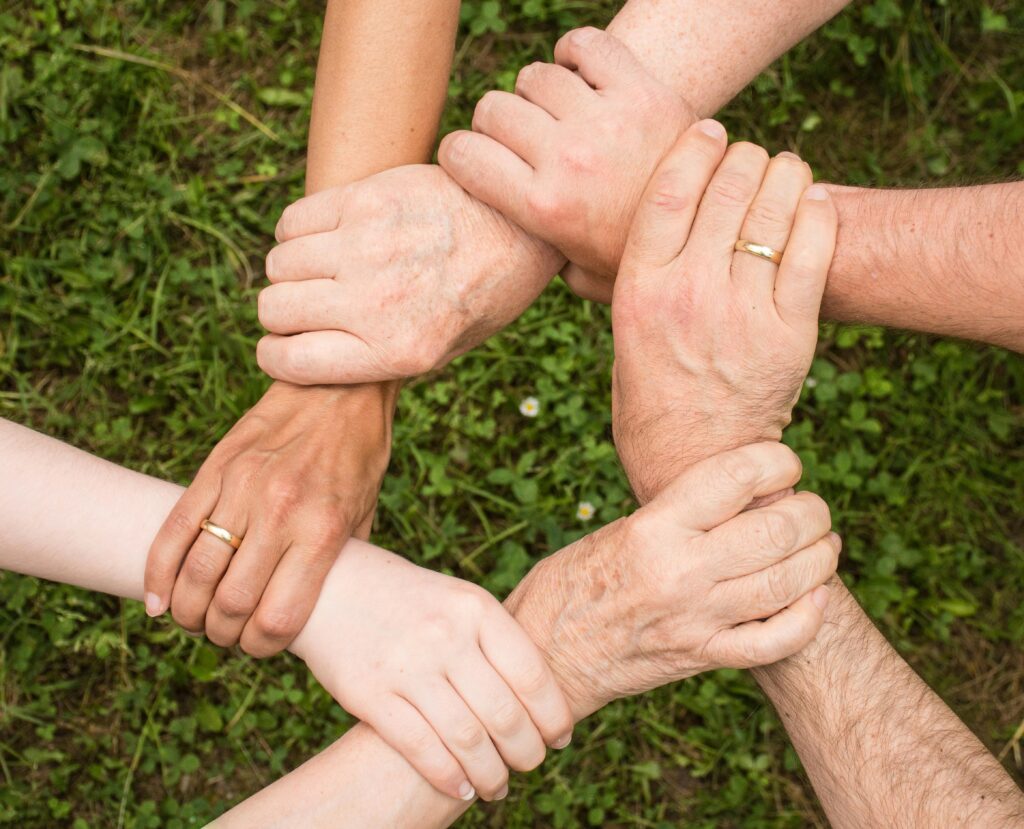 Close-up of diverse hands forming a connection, symbolizing teamwork